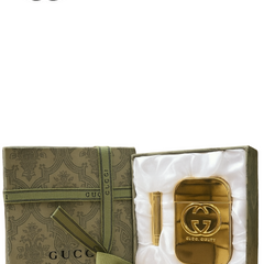 Gold Gucci accessory in a decorative box with Gucci logo on a brown background