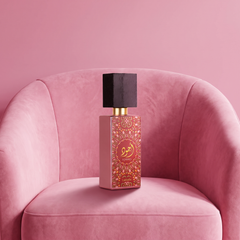 Lattafa Ajwad Pink to Pink on a pink velvet armchair