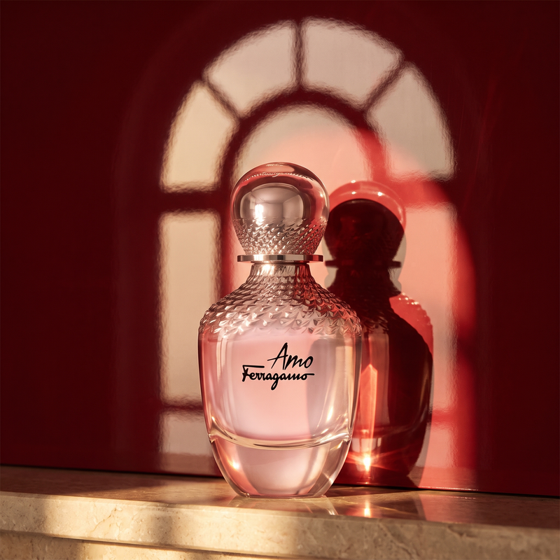 Amo Ferragamo against a lacquered red wall