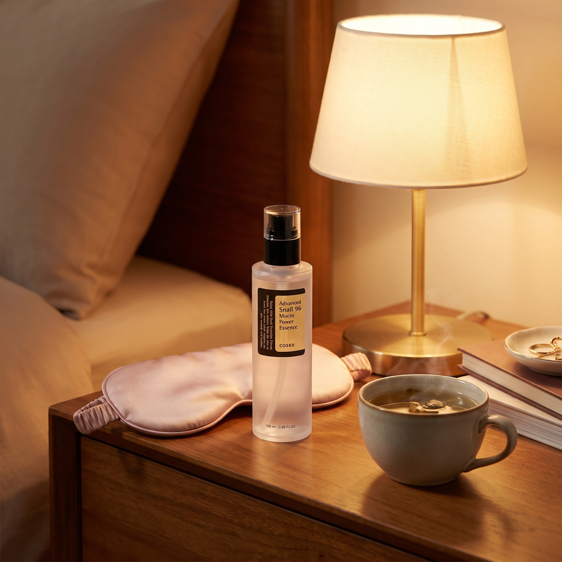 COSRX Advanced Snail 96 Mucin Power Essence on a bedside vanity for the night routine