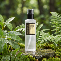 COSRX Advanced Snail 96 Mucin Power Essence among dewy green leaves