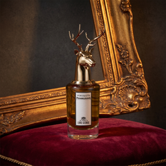 Penhaligon's The Tragedy of Lord George beneath a gilt frame