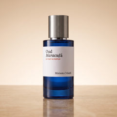 Maison Crivelli Oud Maracuja Extrait de Parfum 50ml bottle on a warm sand-toned surface